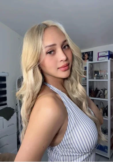 Adult woman with blonde hair in a striped top, editorial portrait
